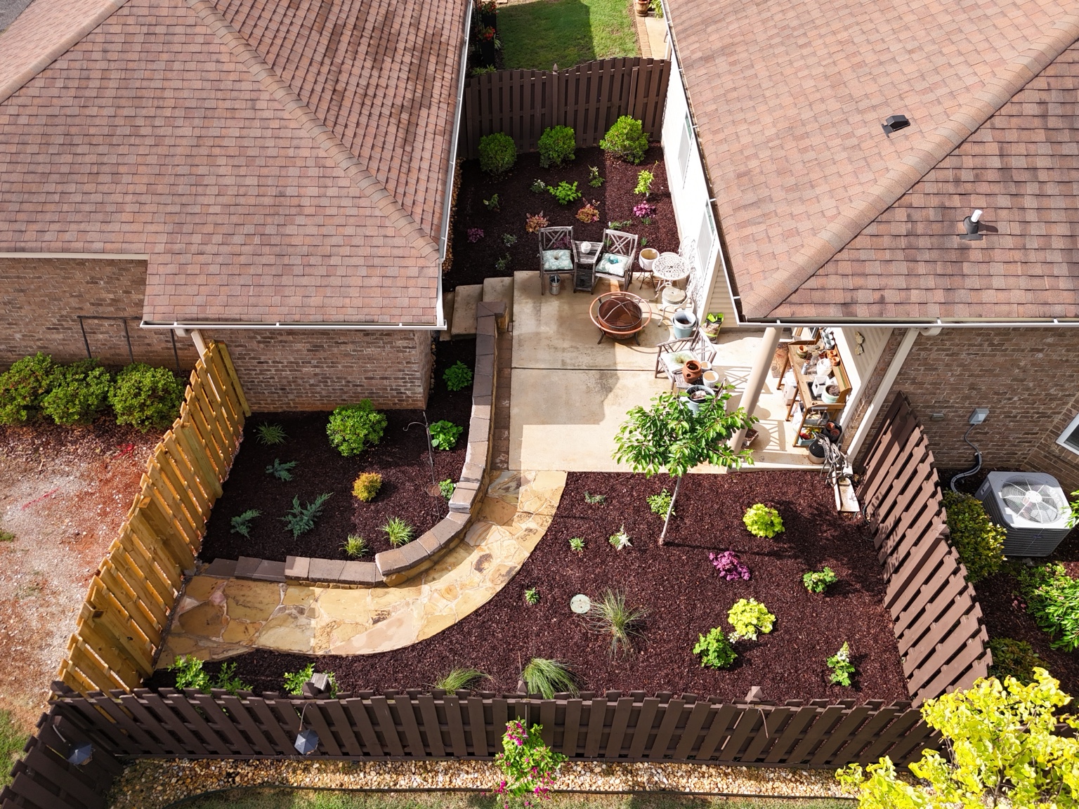 Aerial view of the completed courtyard path, patio, retaining walls and planting